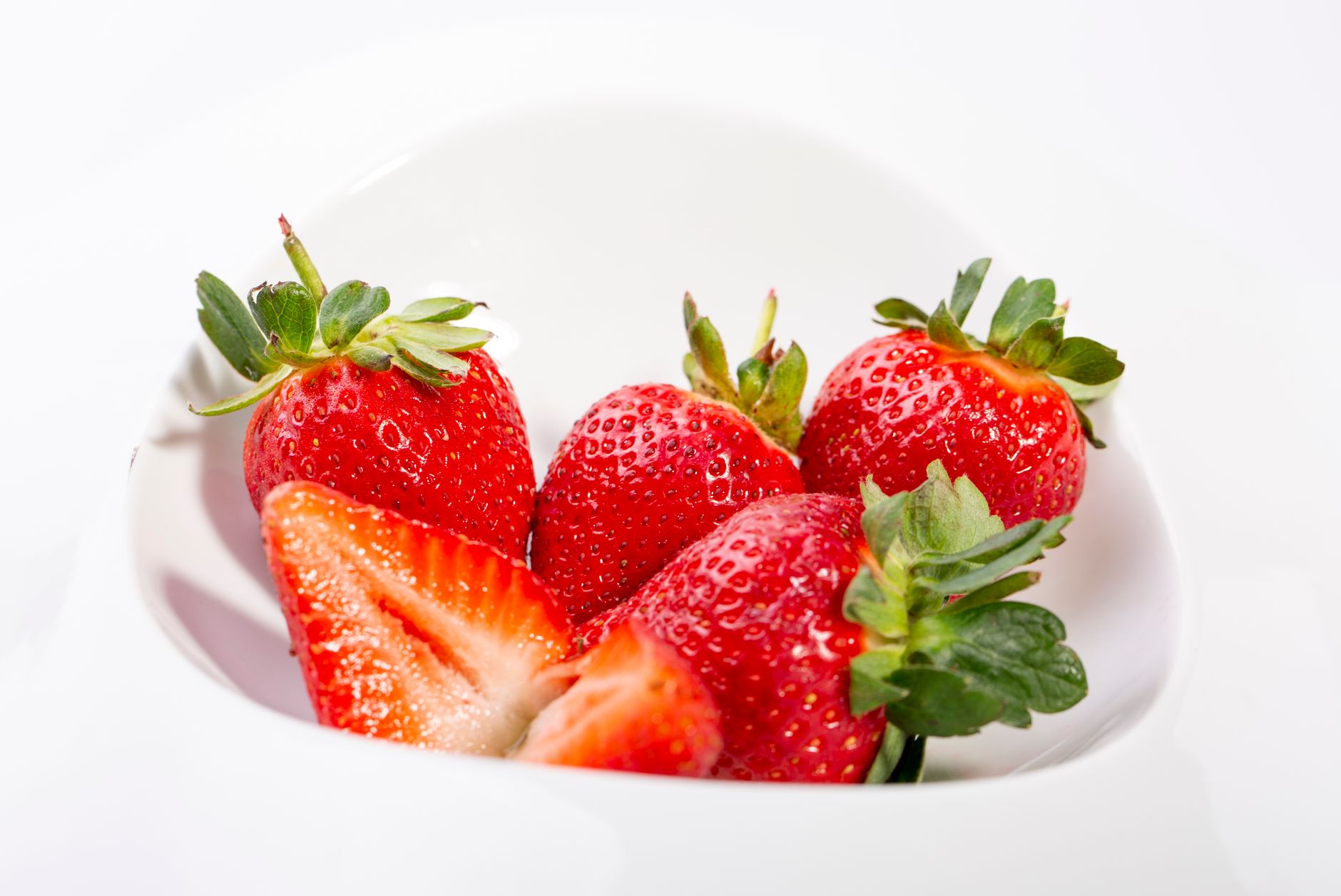 Sliced ripe strawberries in a bowl, prepped for jam