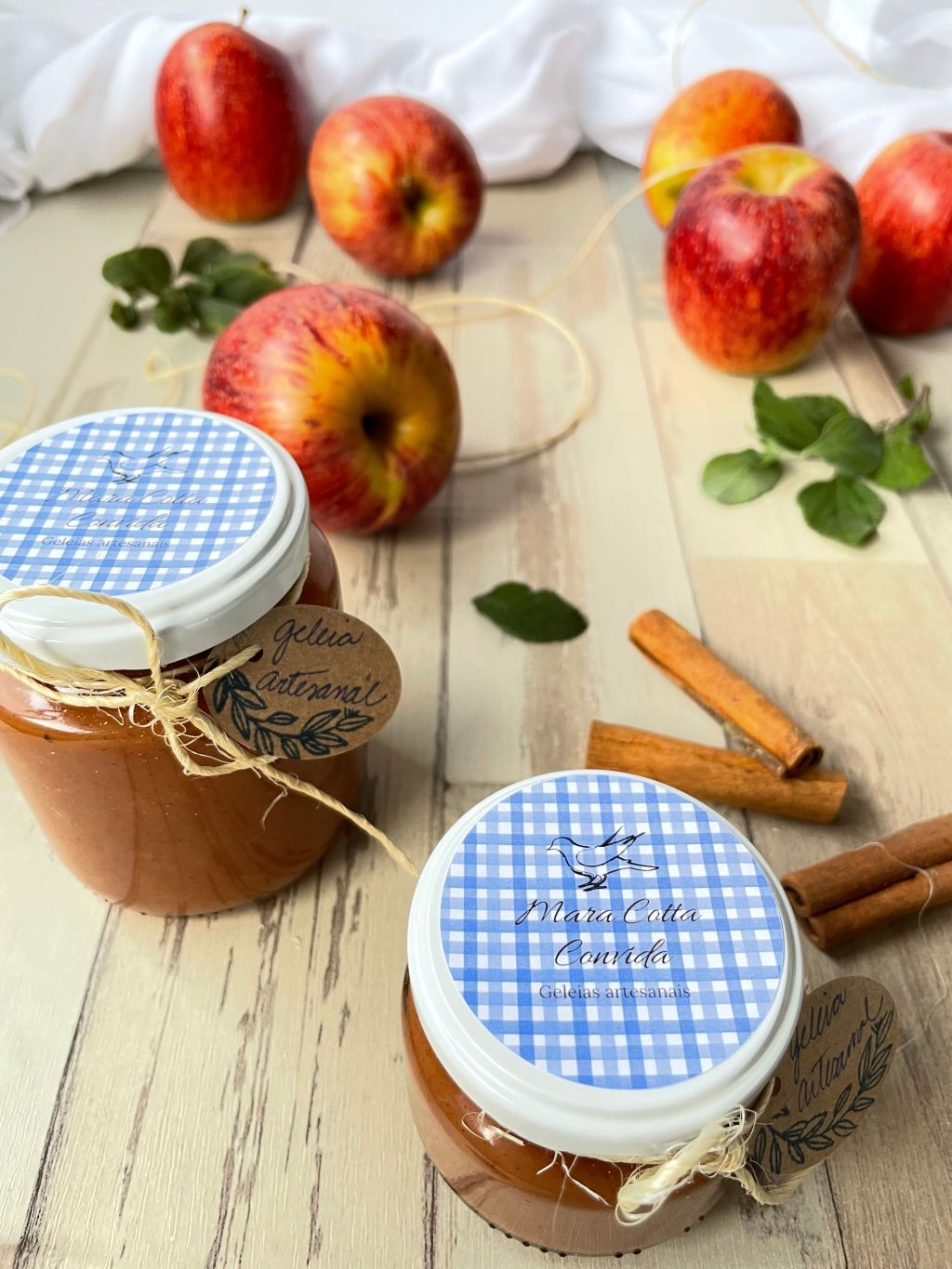 Jar of homemade apple butter with fresh apples